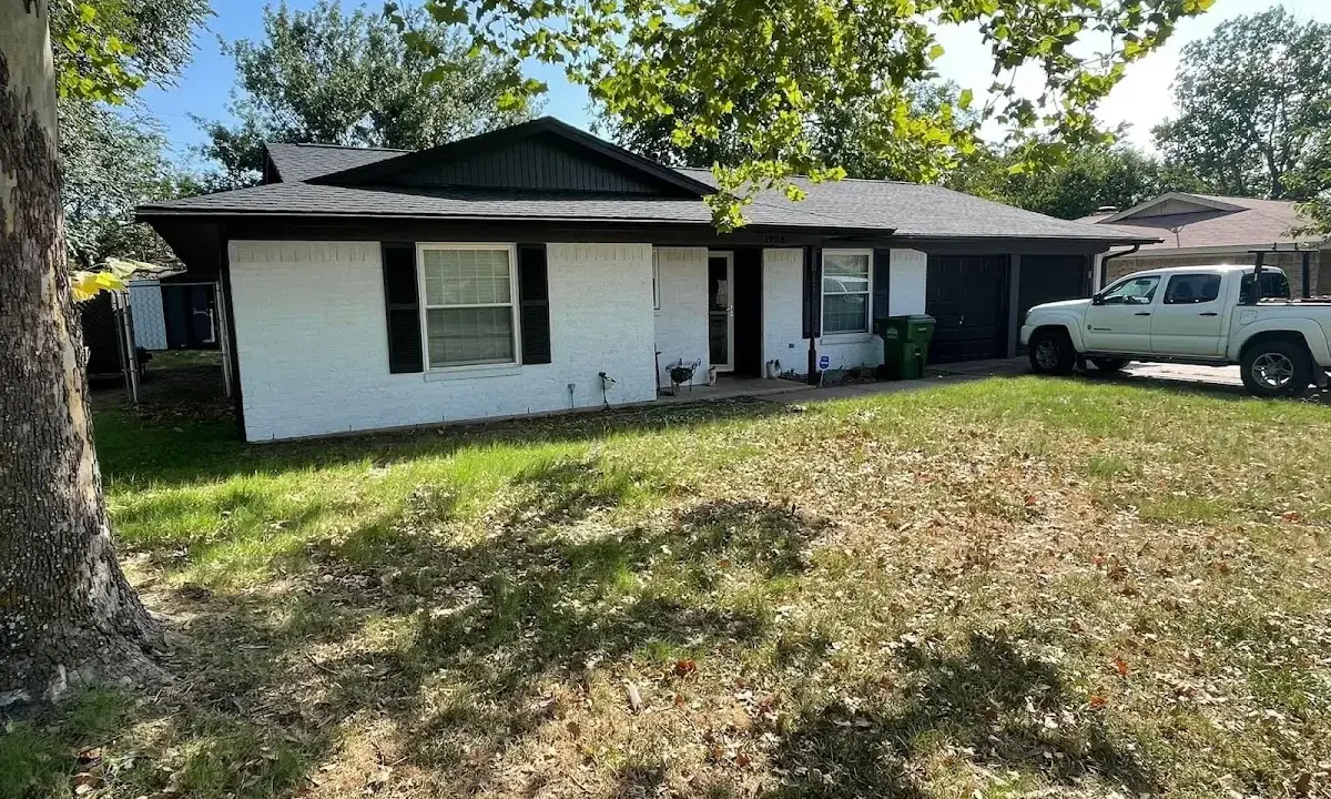 Professional roofing crew working on a residential roof in Glen Cove